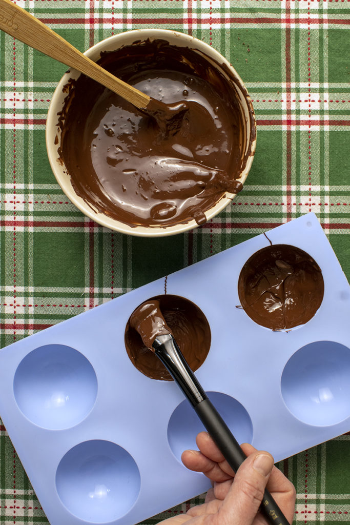 painting molds with melted chocolate