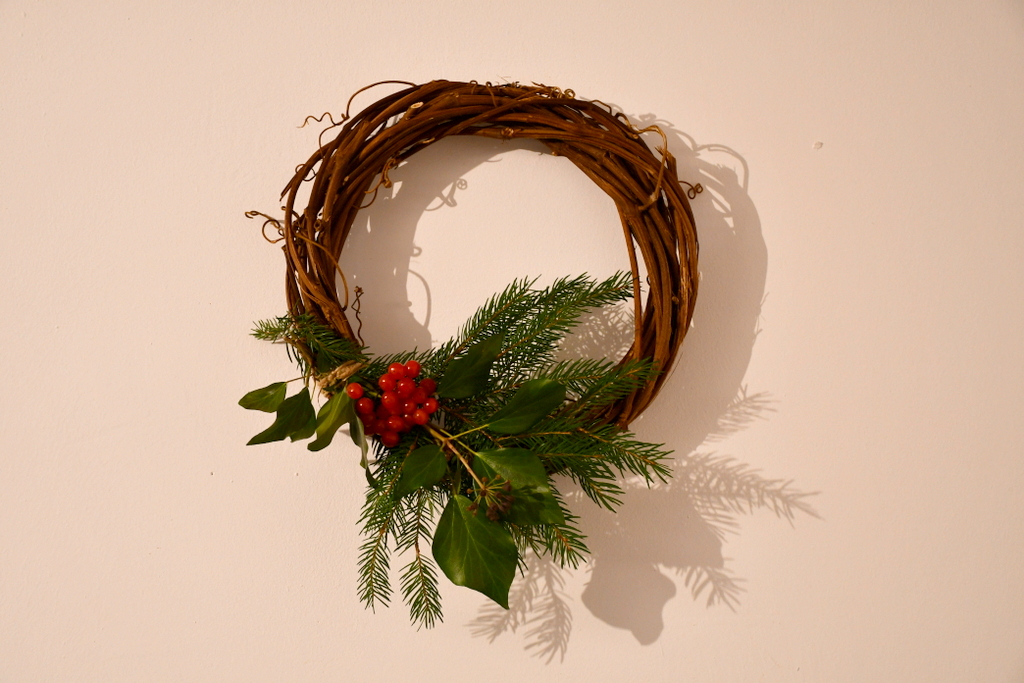 Miniature wreath with a small bunch of leftover greenery.