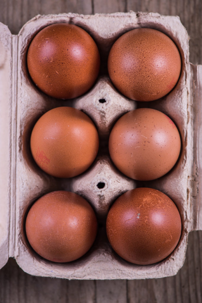 deep brown chicken eggs in carton