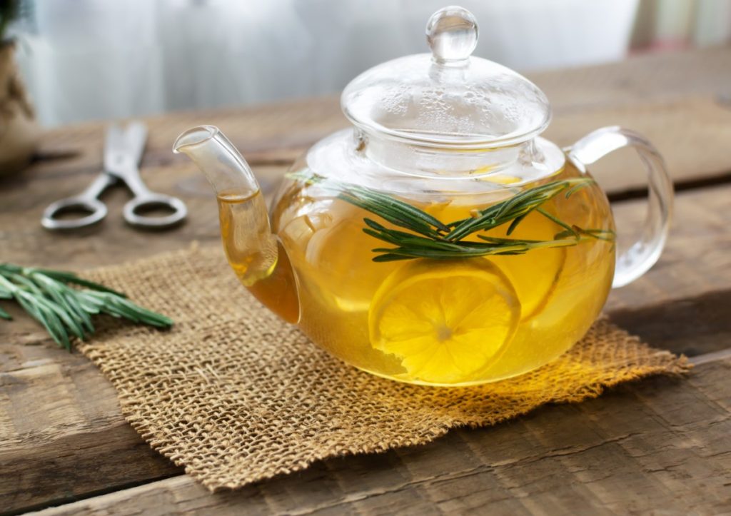 Tea pot with lemons and rosemary tea