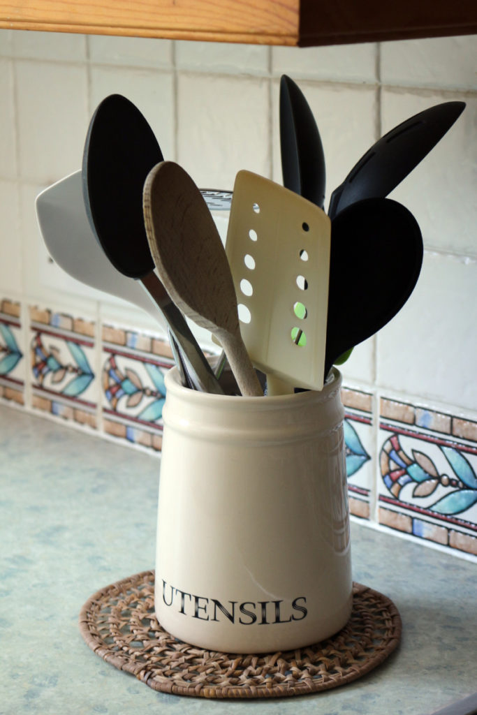utensil crock filled with plastic spoons.