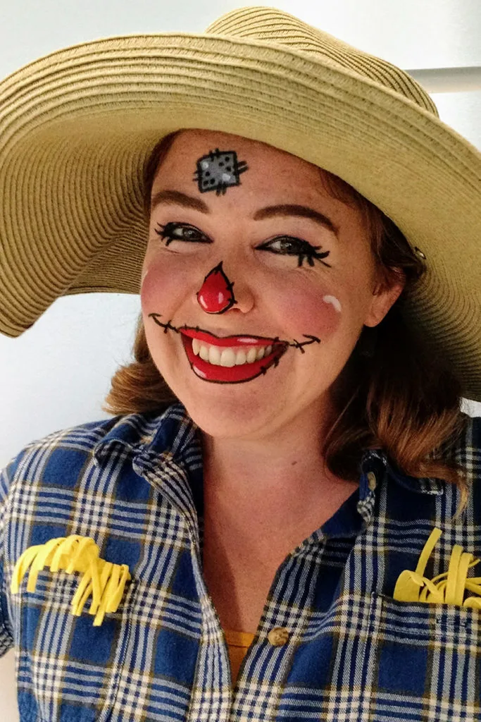 Author dressed as scarecrow wearing a sun hat