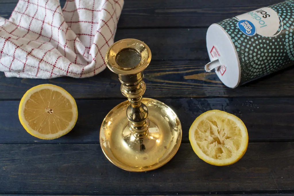 Lemons sprinkled with salt being used to clean brass.
