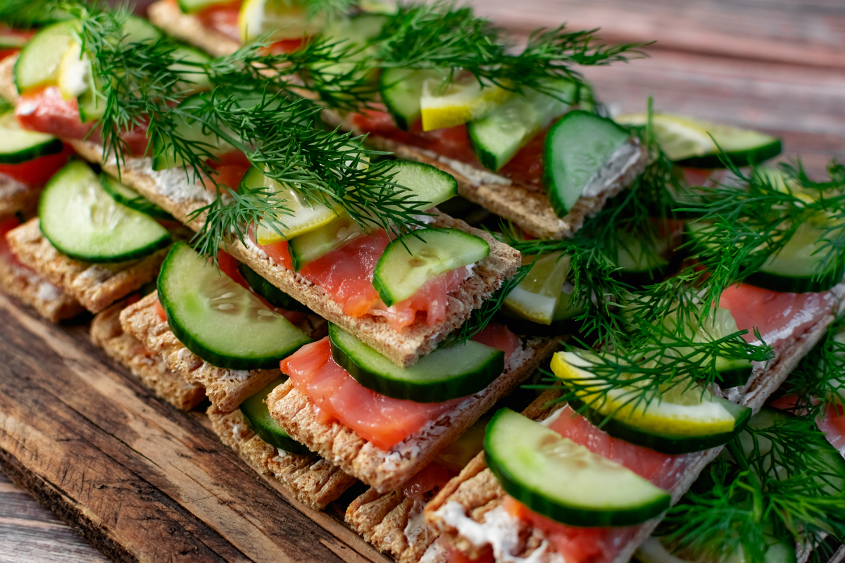 Flat breads wtih cream cheese, salmon, cucumbers and dill on top. 