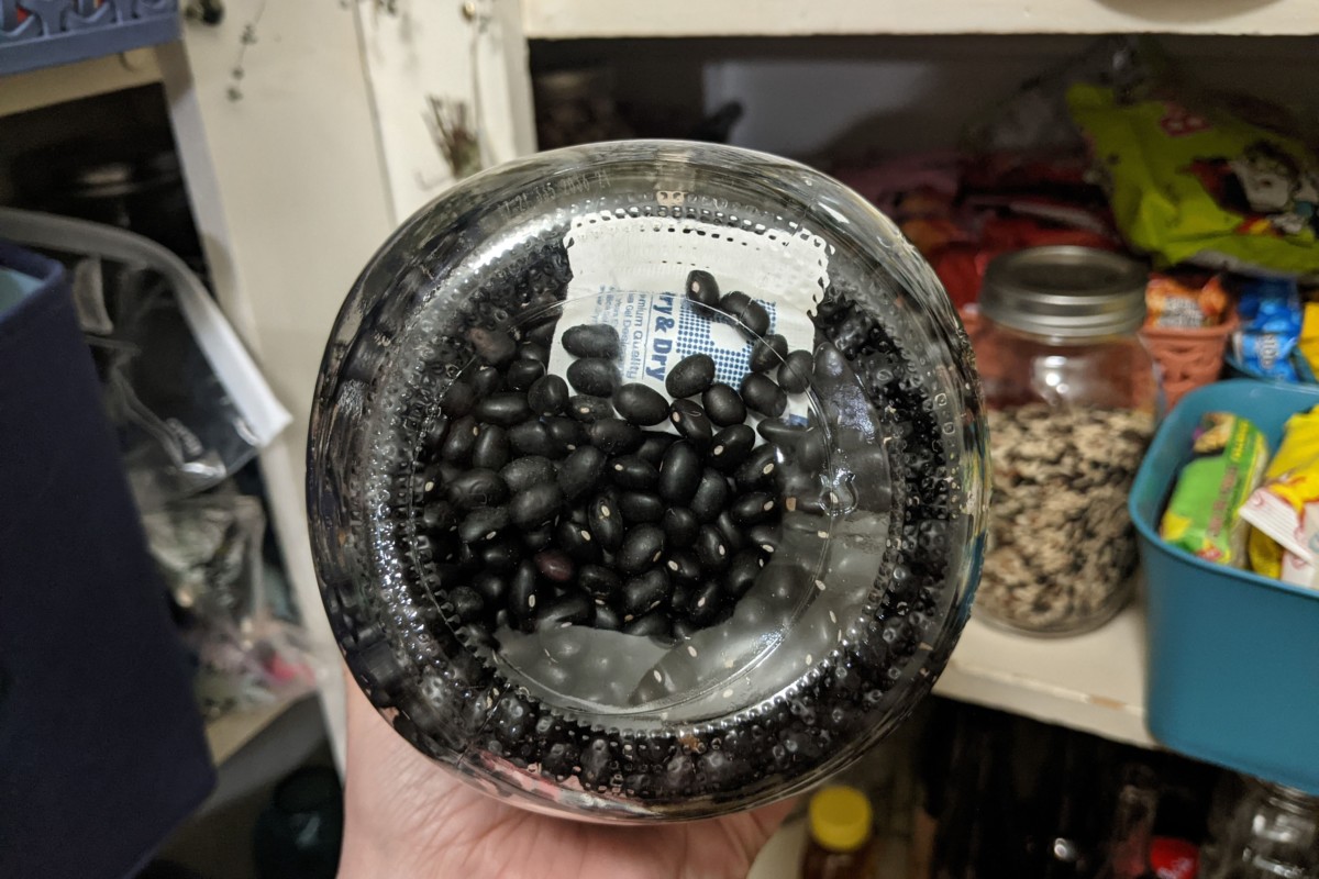 Bottom of jar of beans with a packet of desiccant.