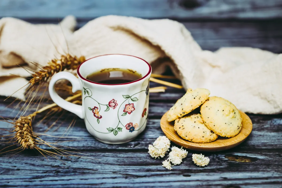 A plate of chamomile cookies with a mug of tea.