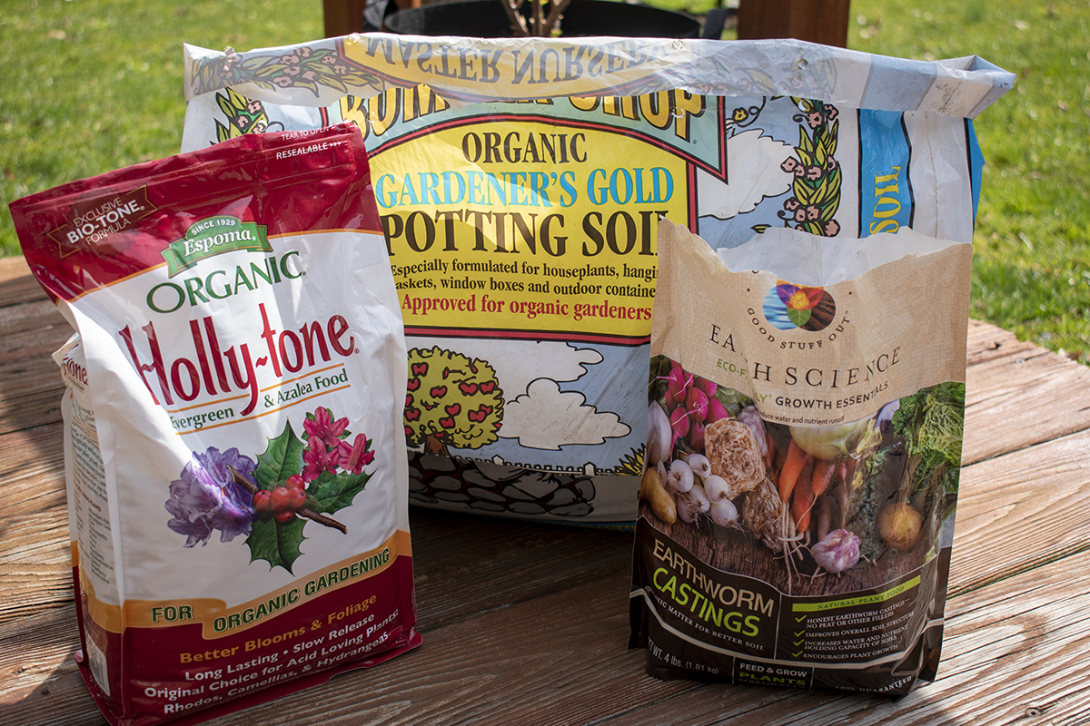 Holly-tone fertilizer, potting soil and worm castings in bags.