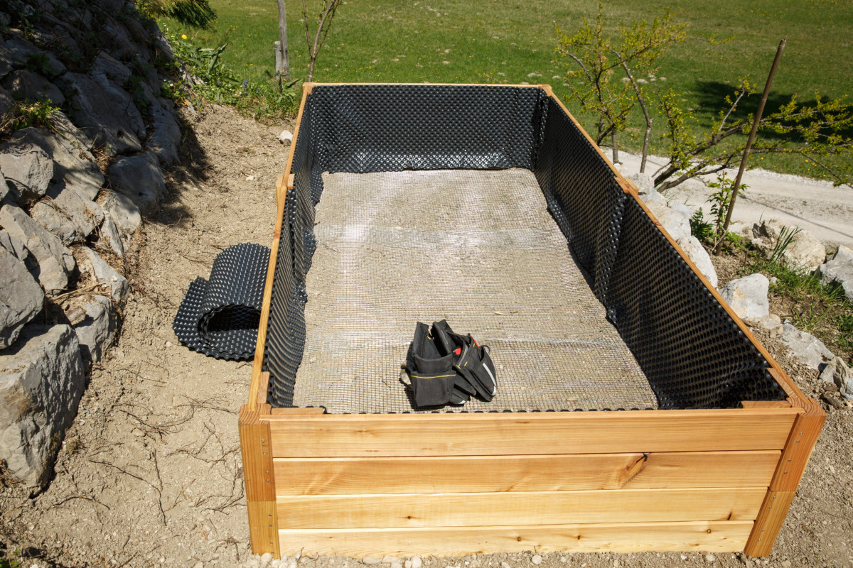 Raised bed being built with liner. 