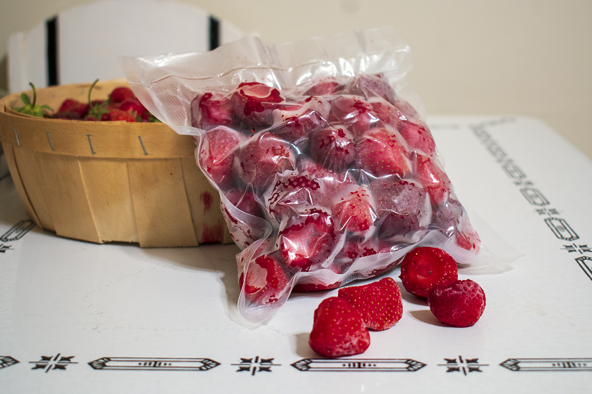 A bag of flash frozen berries on kitchen table.