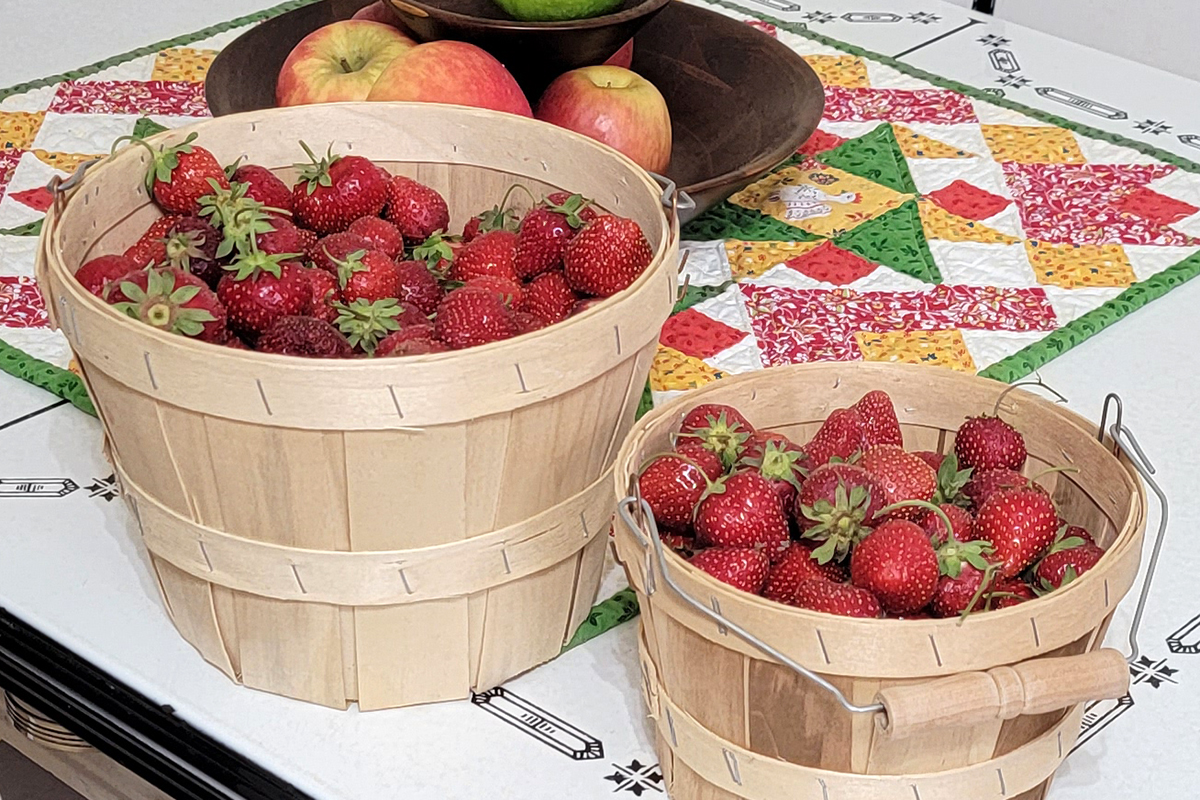 Two baskets filled with fresh-picked strawberries