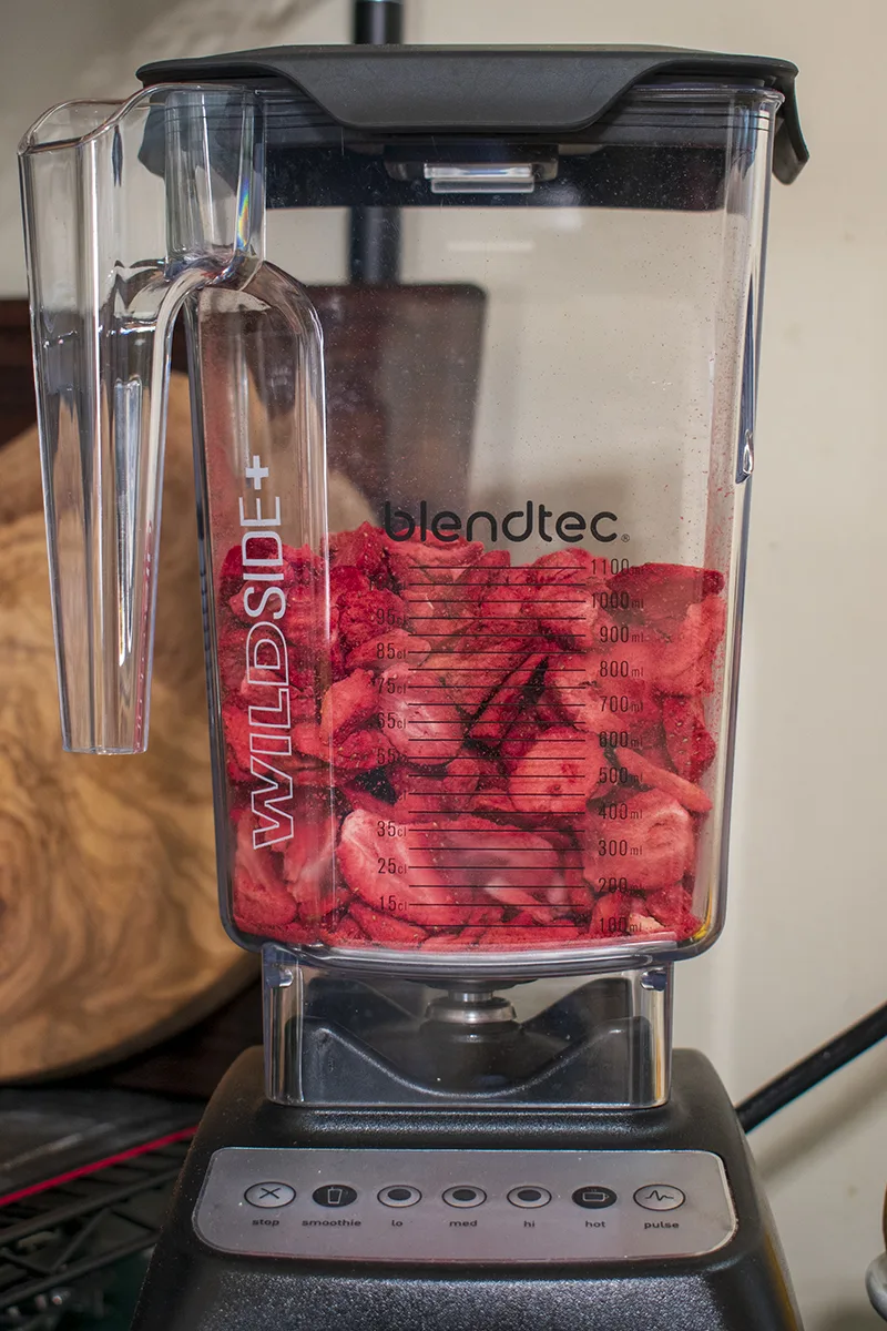 Blender jar full of dried strawberries
