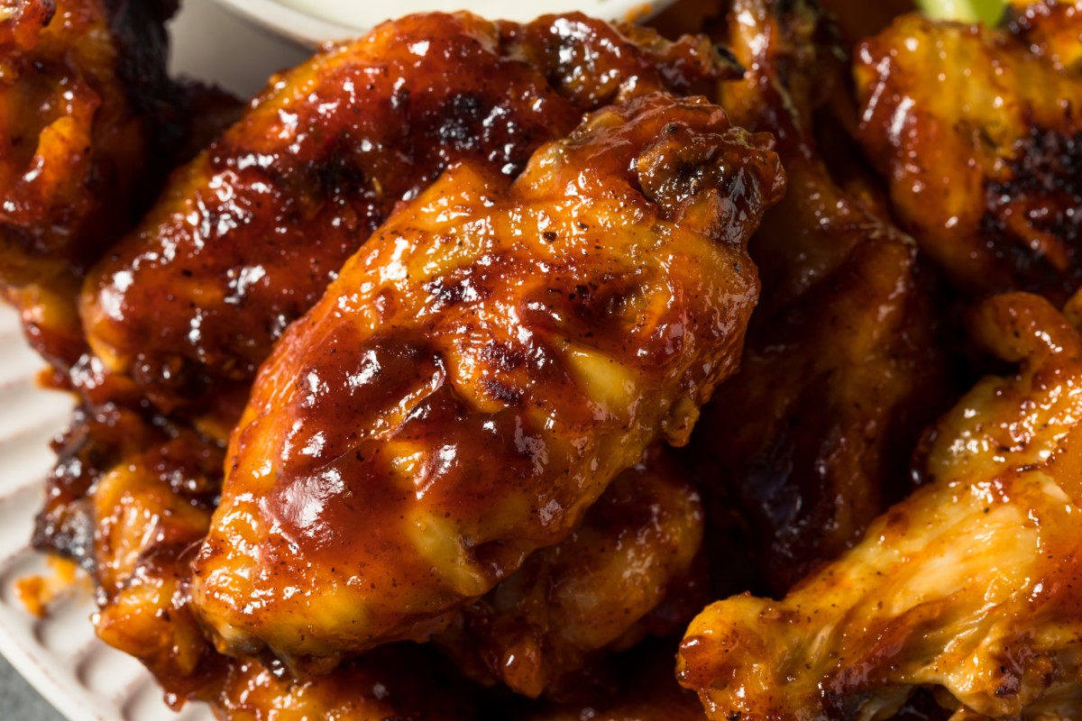 Chicken wings covered in blueberry barbecue sauce.