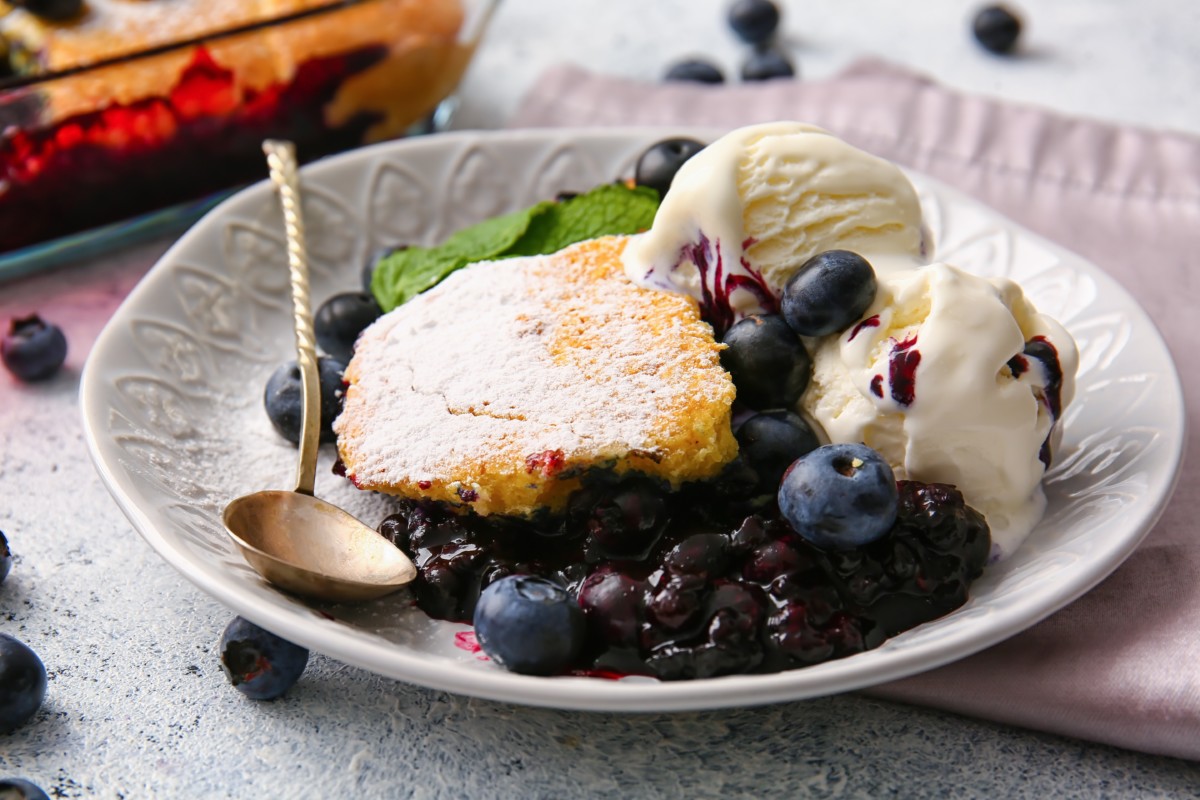 A dish of blueberry cobbler with vanilla ice cream