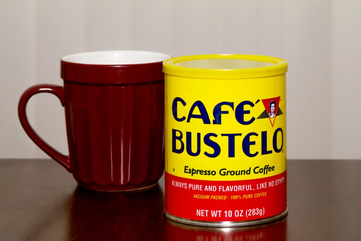 A coffee mug and a tin of coffee. 