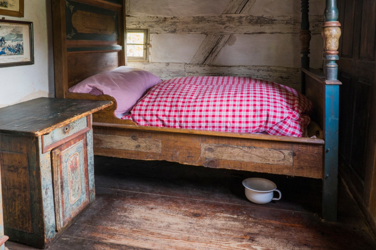 Old fashioned bed with a chamber pot beneath it. 