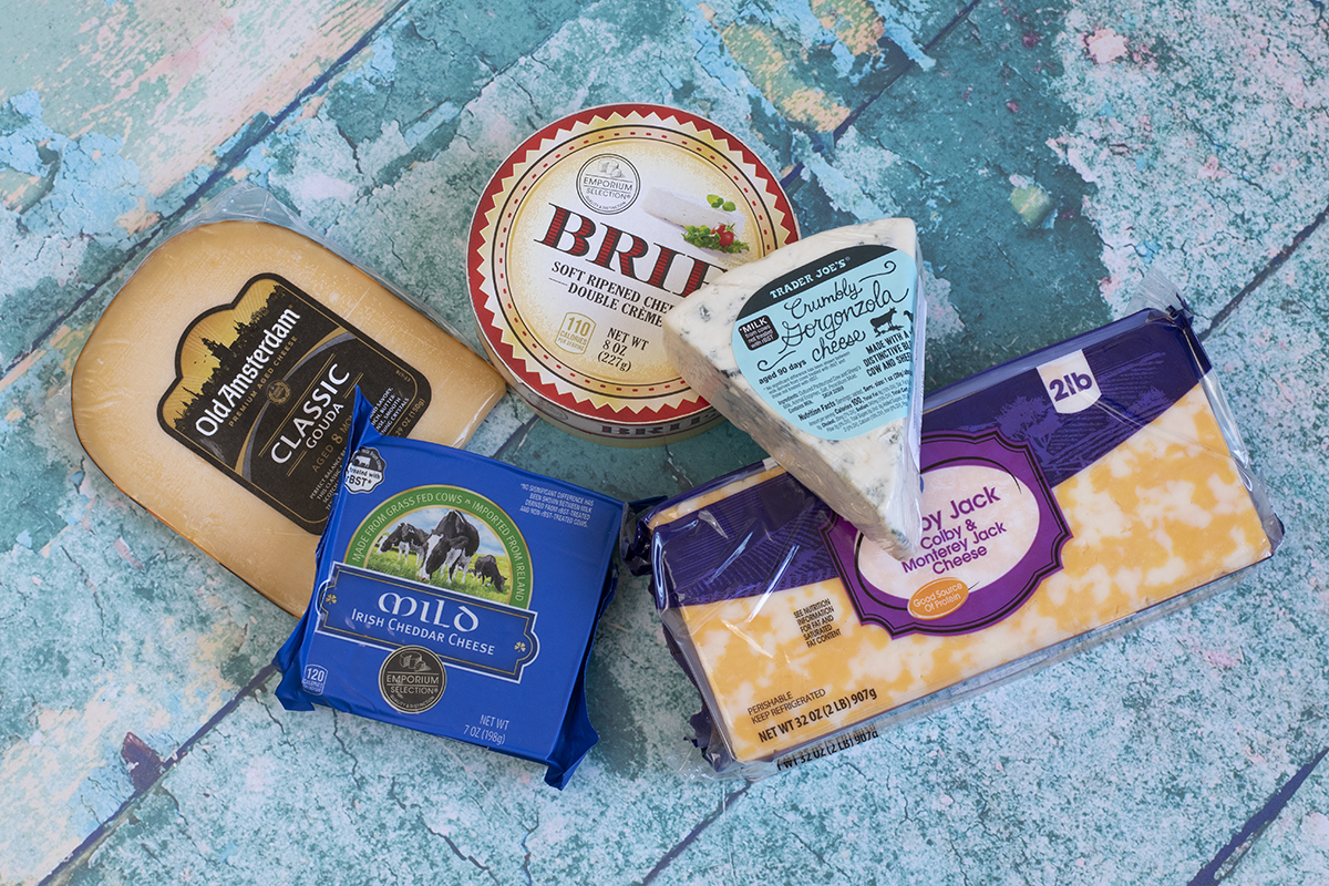 Overhead view of several different types of cheeses. 