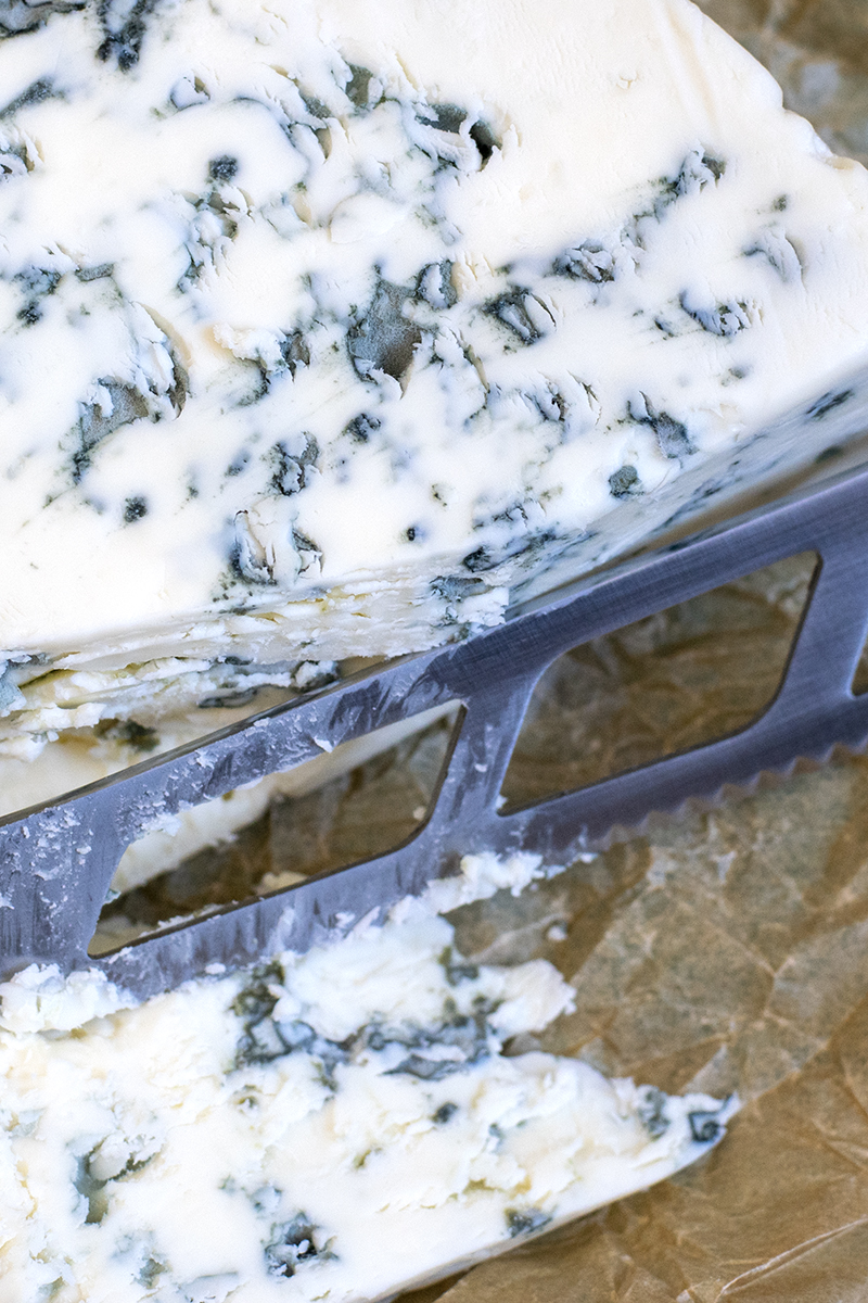 Close up view of the moldy green patches in gorgonzola.