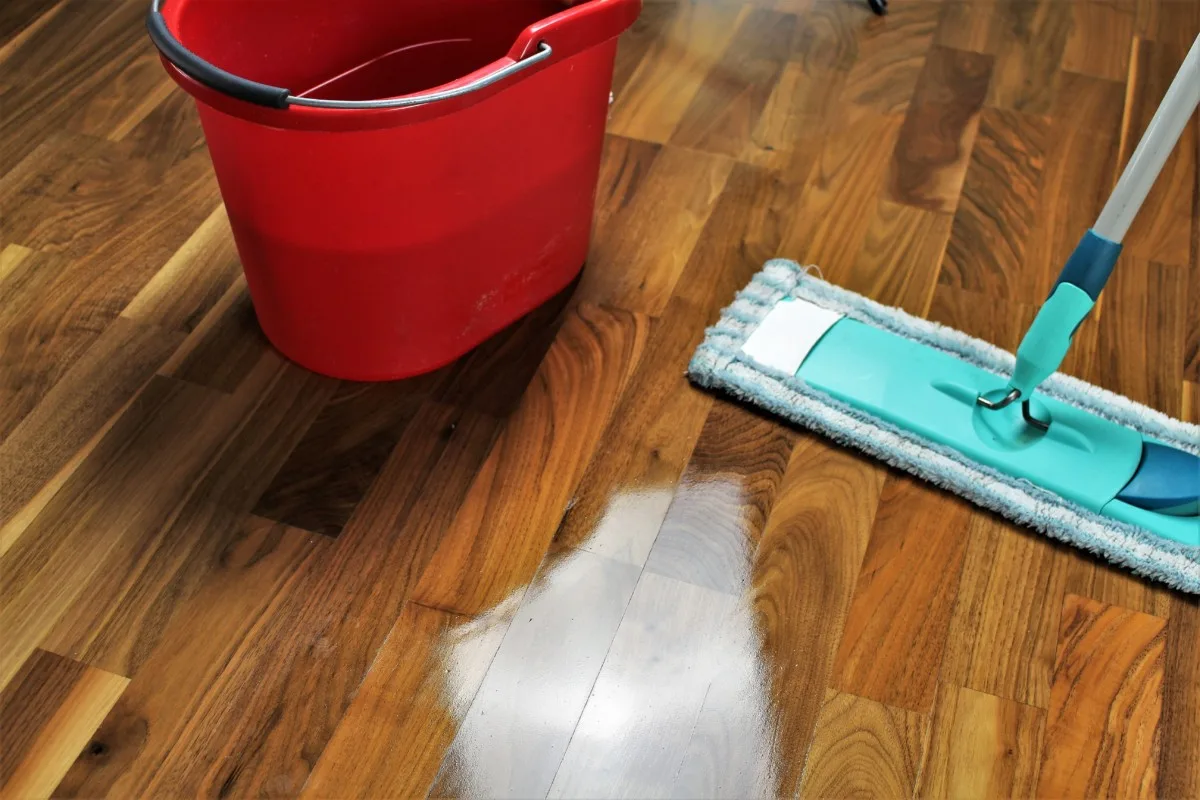 Shiny wood floors, mop and bucket. 
