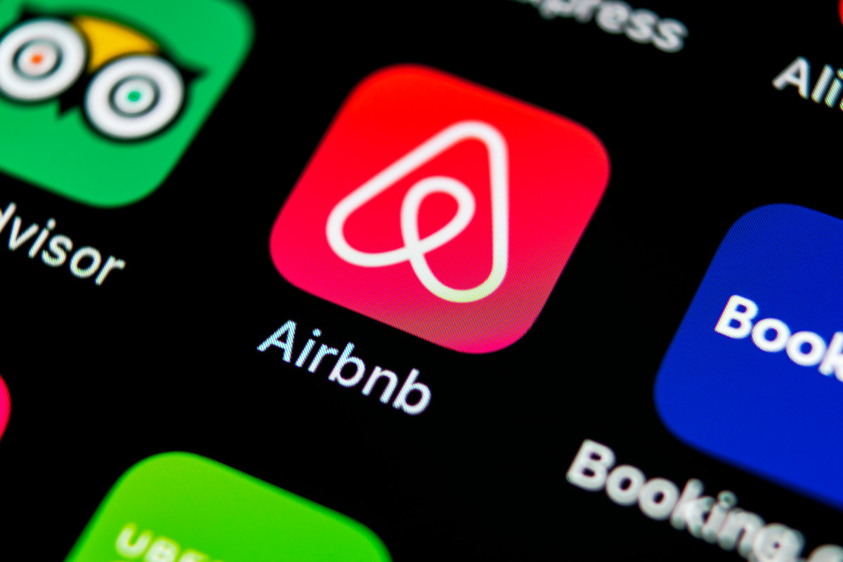 Close up of Airbnb app icon on a mobile phone screen.