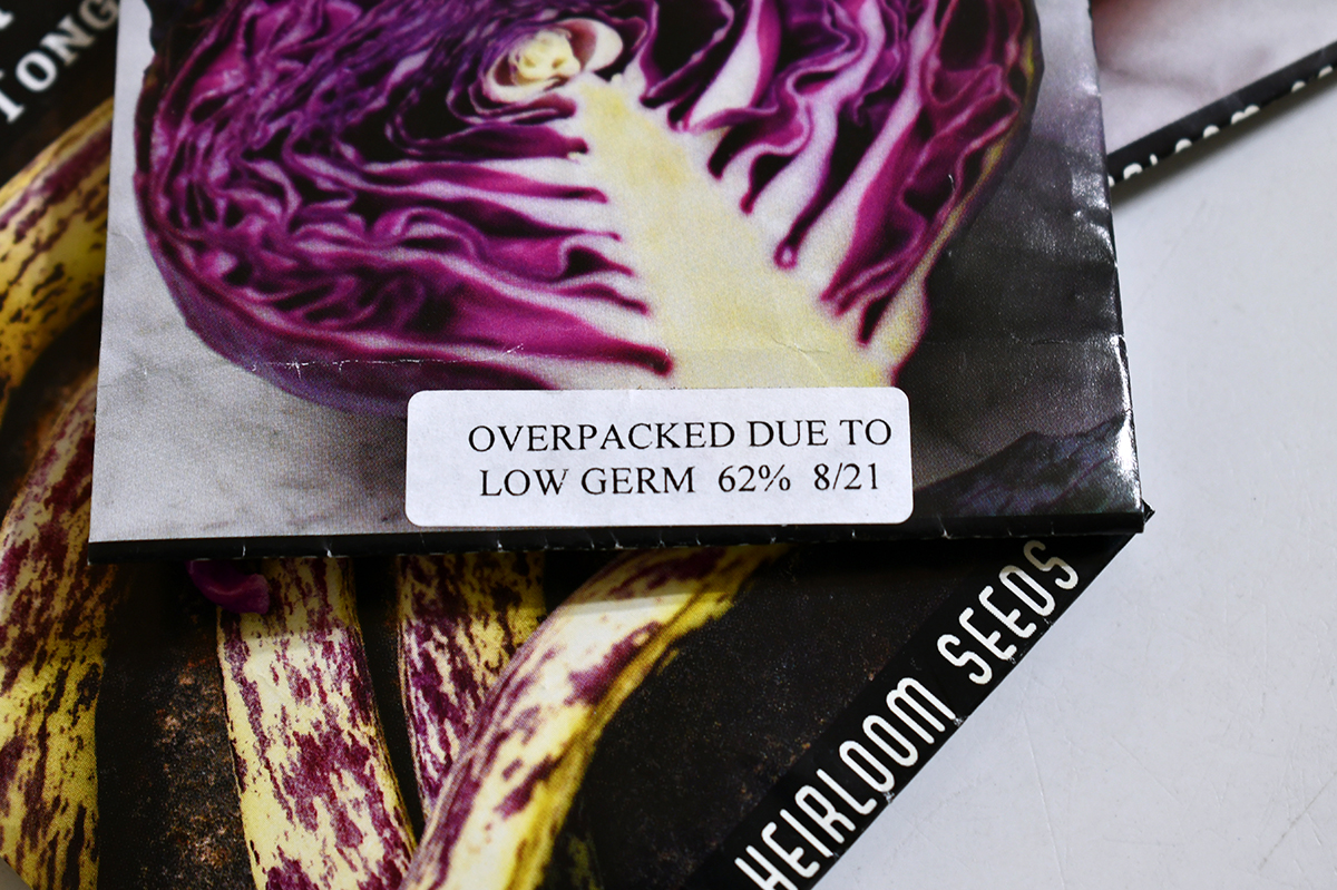 Seed packet with sticker that reads, "Overpacked due to low germ 62% 8/21"