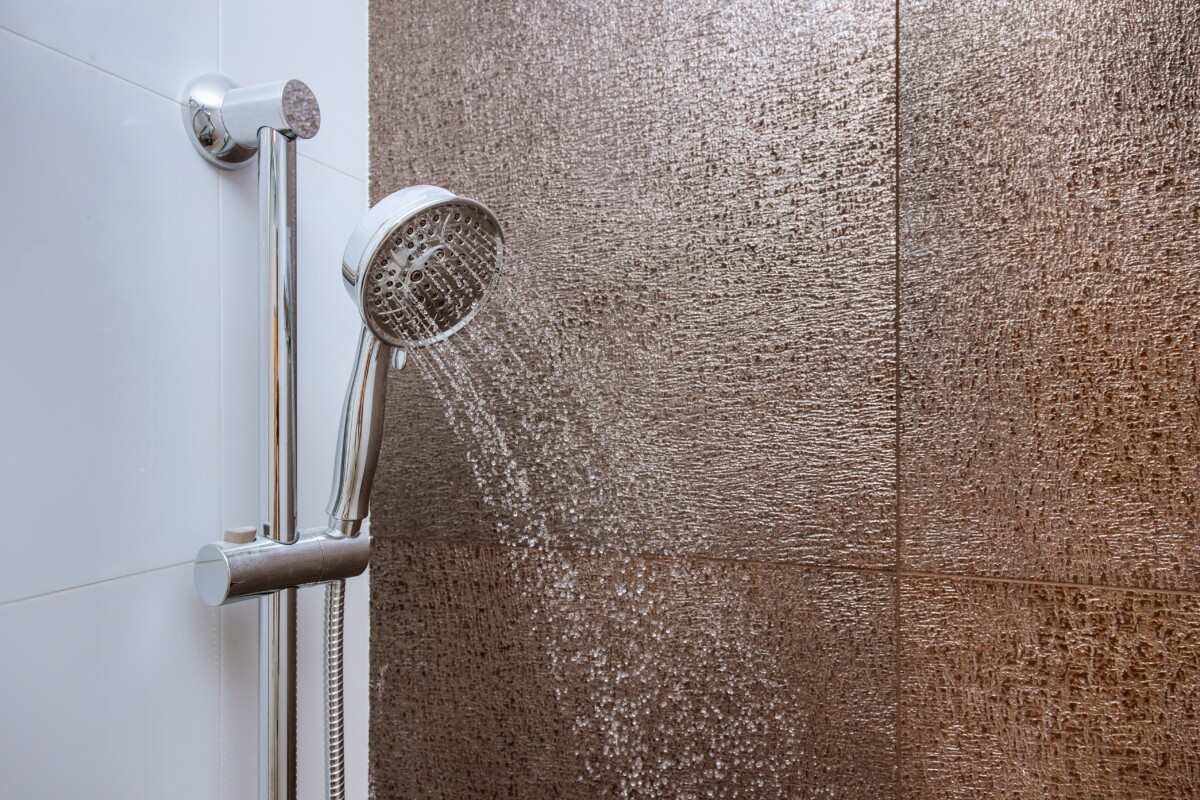 Showerhead spraying water in a shower.