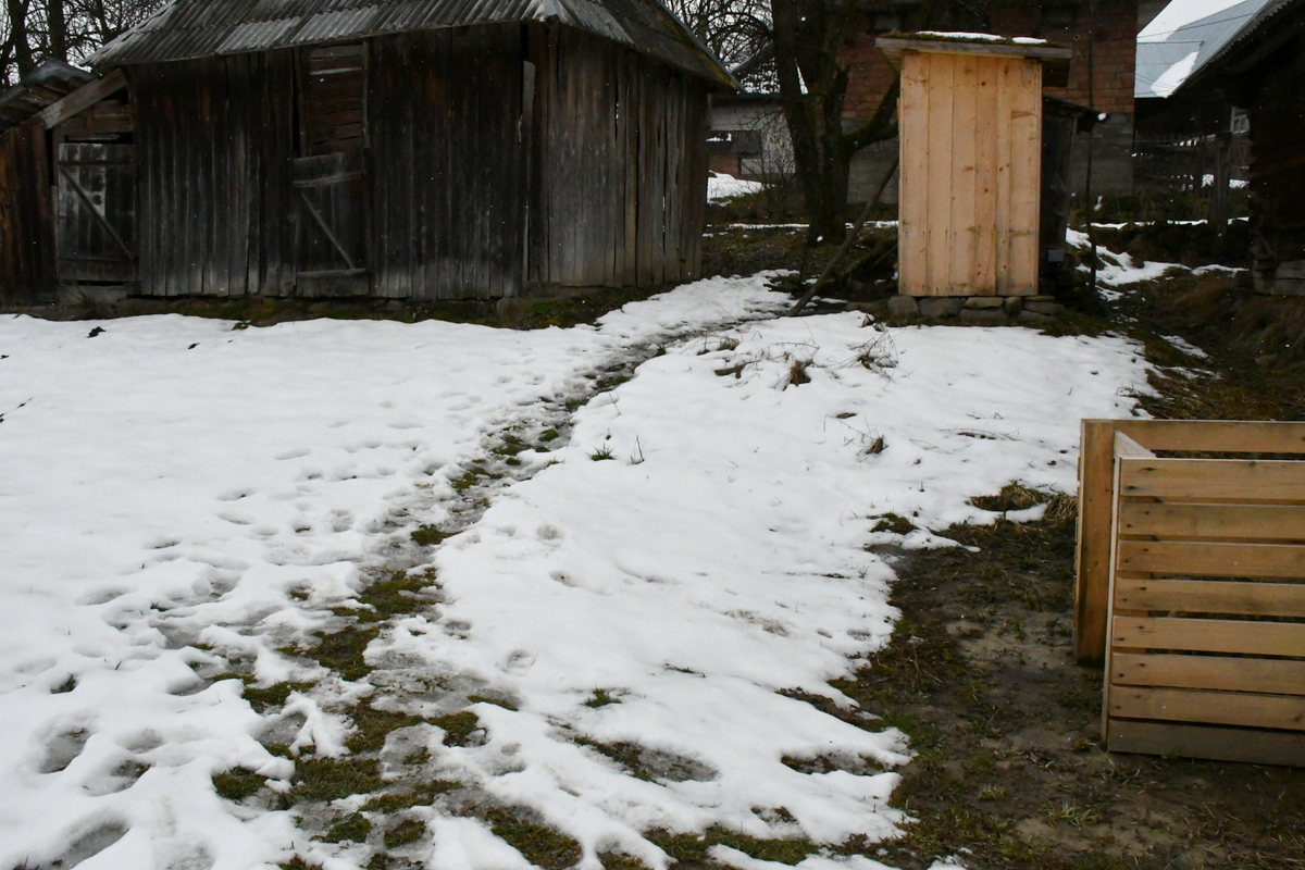 Snowy yard with slushy path