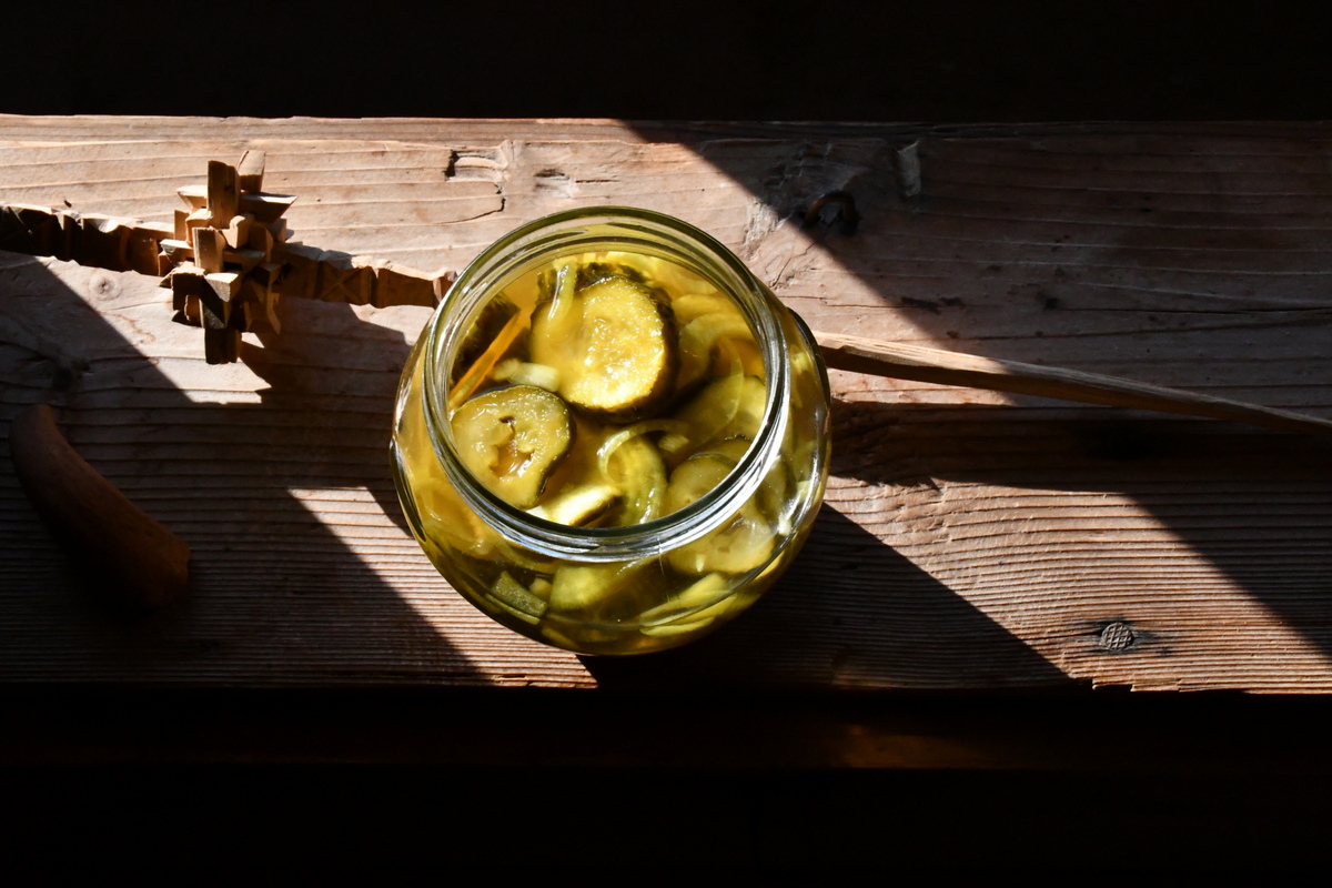 Jar of bread and butter pickles in the sun.