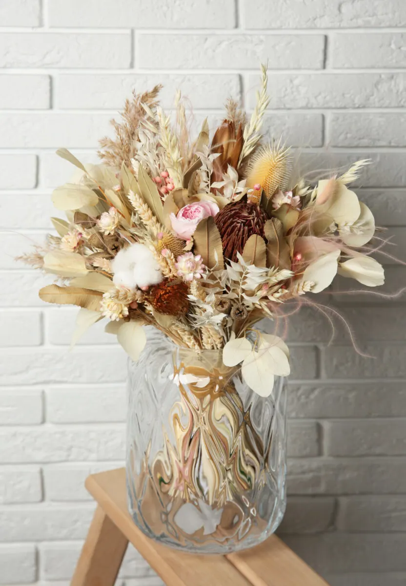 Large dried floral arrangement in vase
