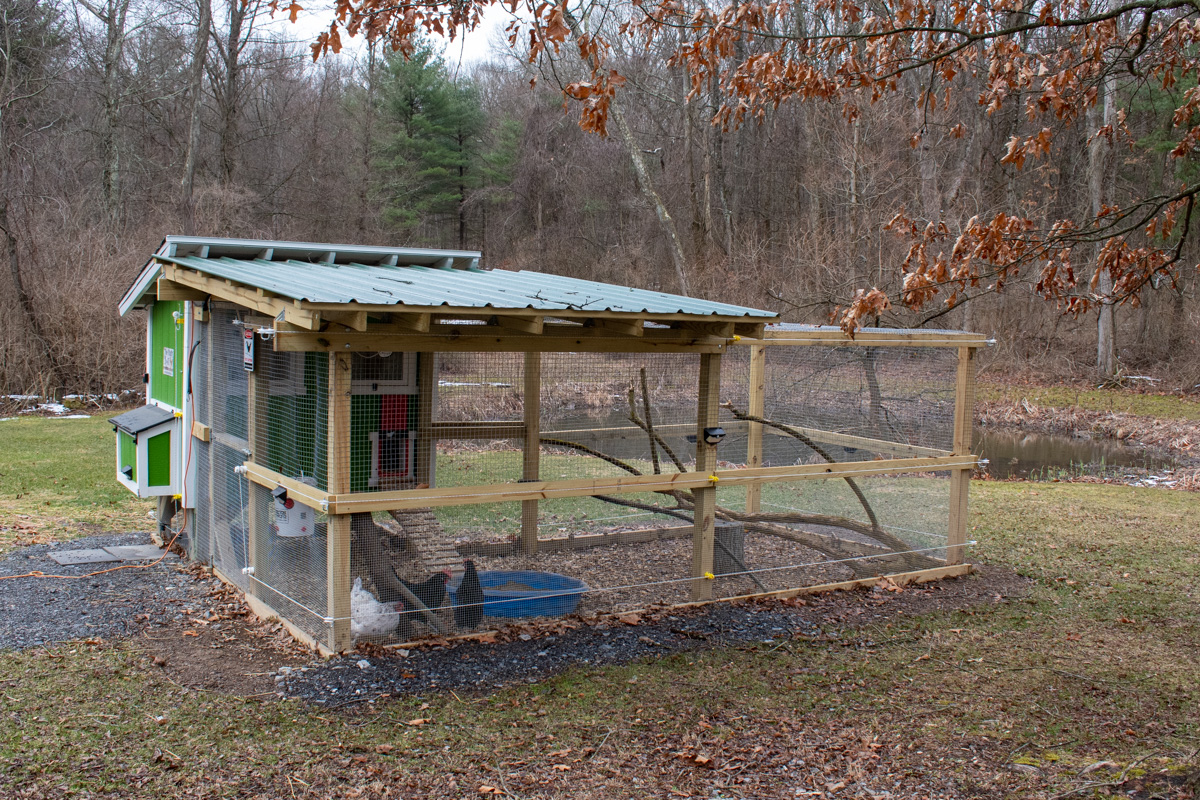 Chicken coop with electric fencing around run.