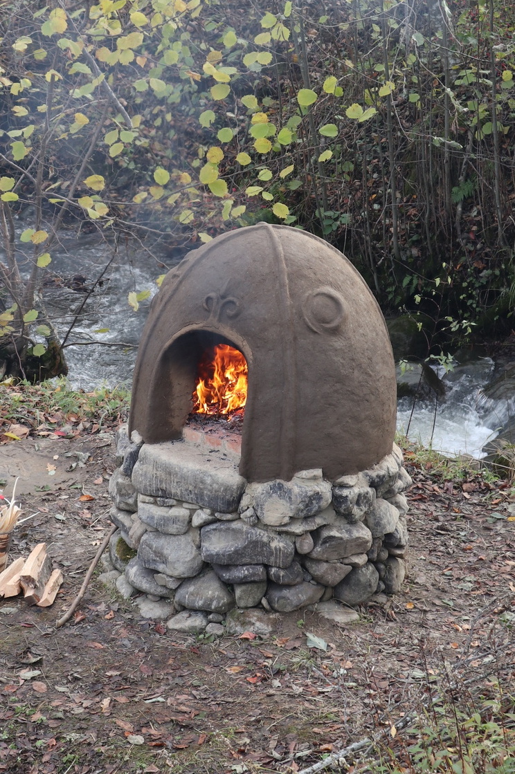 Cob oven with a fire in it