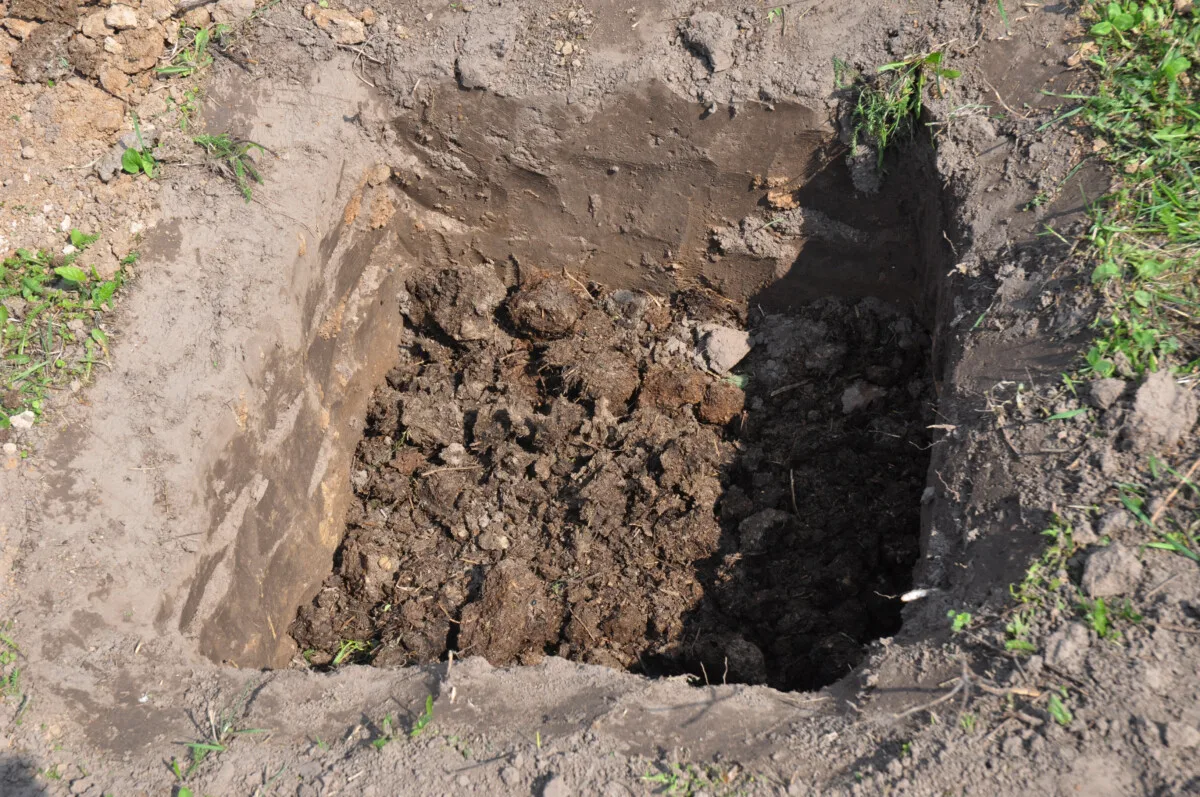 A square hole dug in the ground