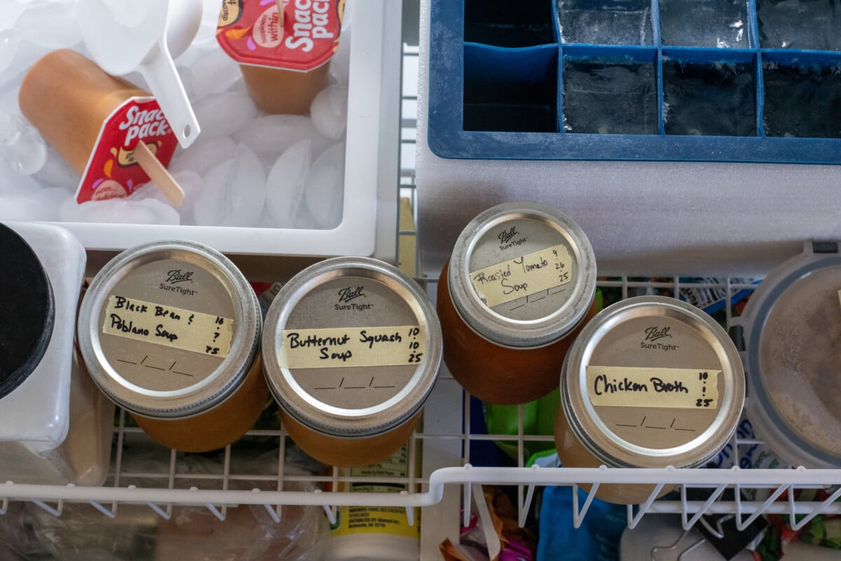 Jars of soup in a freezer