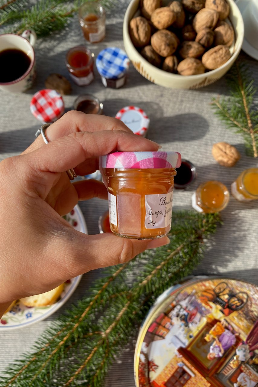 Woman's hand holding jam jar