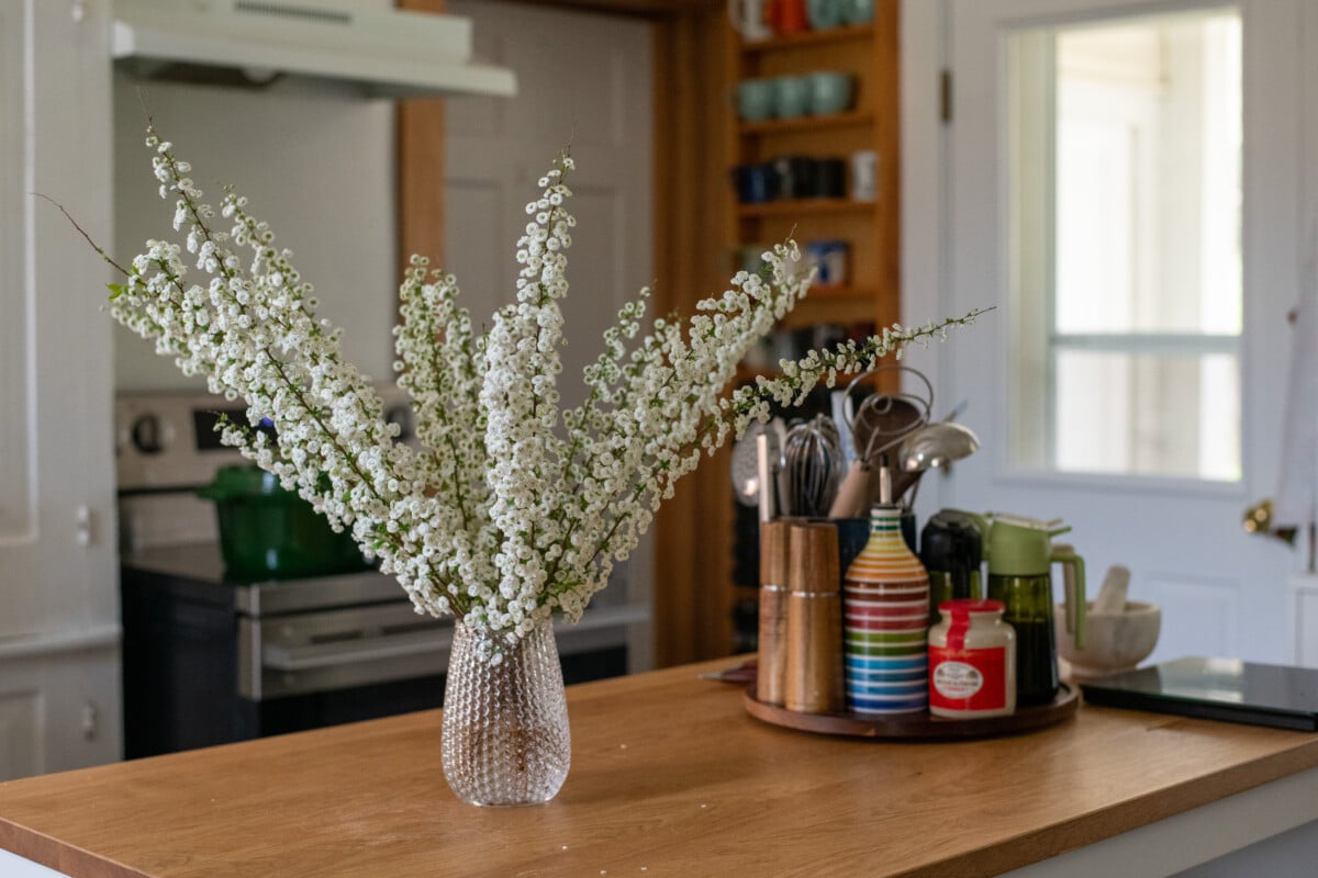 Bridal wreath spirea in a vase on a kitchen island