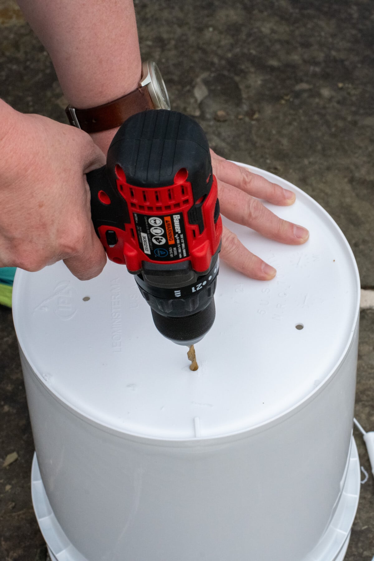 Drilling holes in bottom of bucket