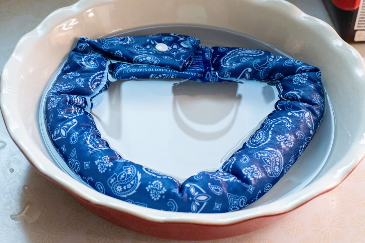 Evaporative neck wrap soaking in water
