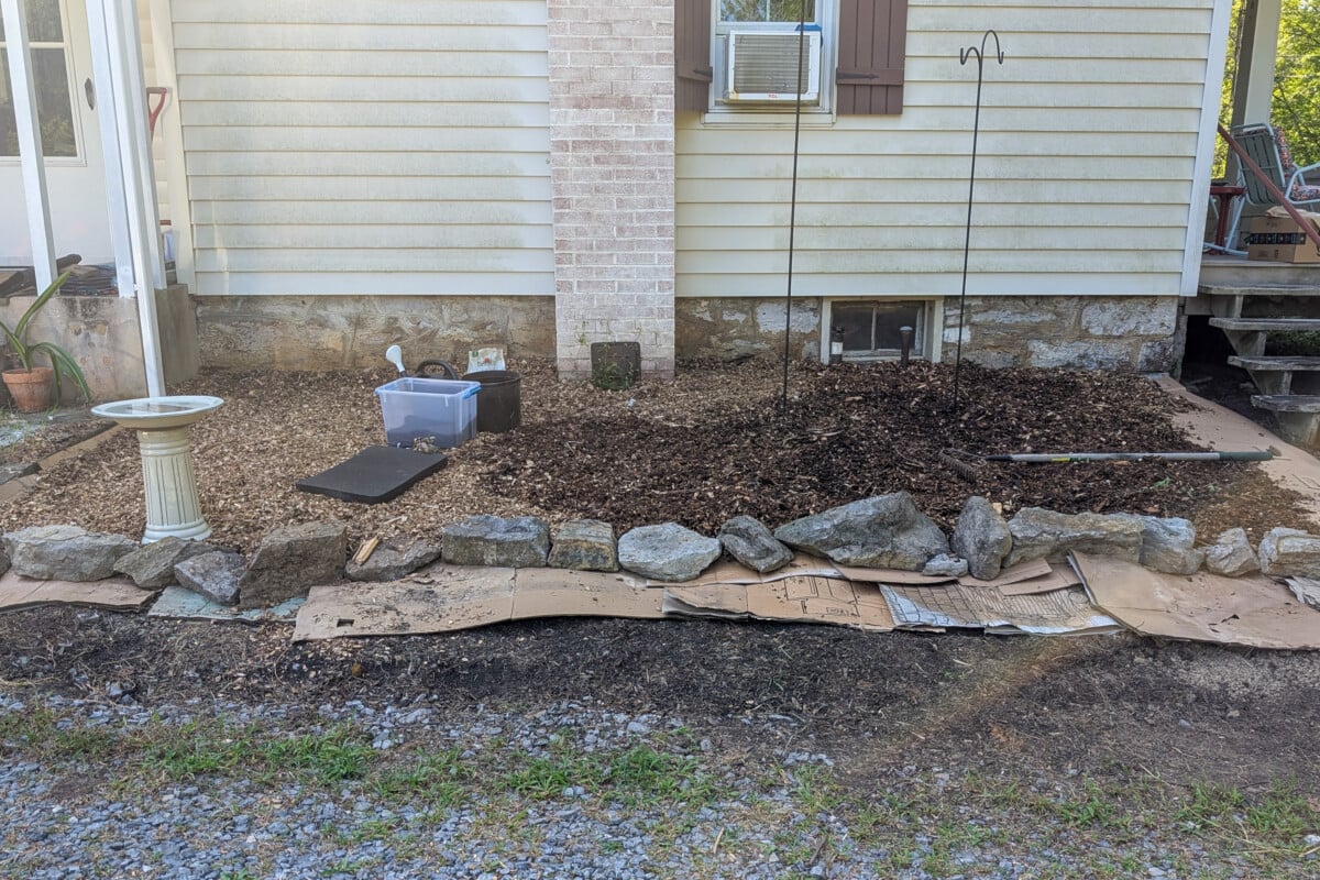 Flower bed covered in cardboard and wood chips