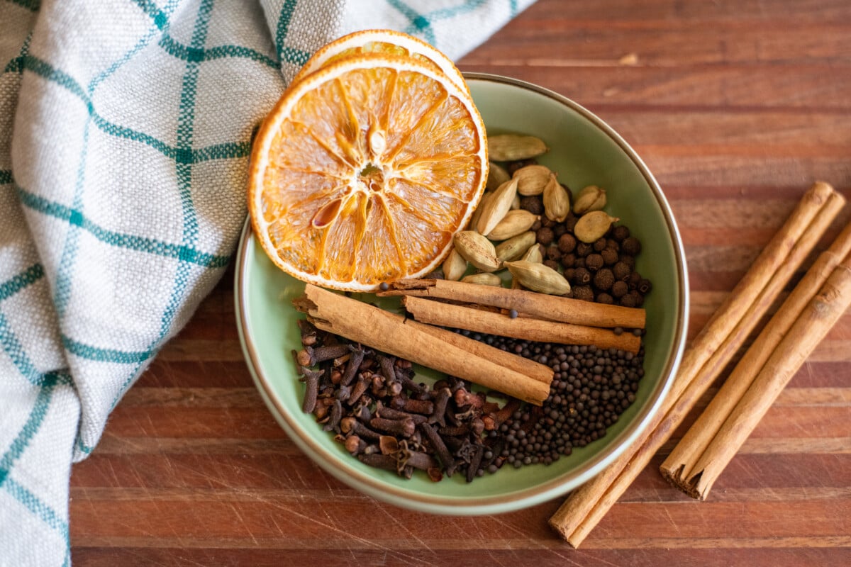 Small dish filled with pickling spices and desiccated orange slices